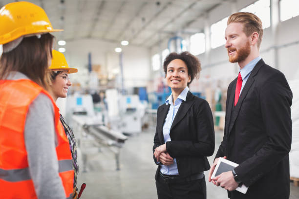 istock Quality inspectors talking to workes in factory 654878872
