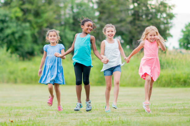 istock Friends Holding Hands and Playing Outside 654902748