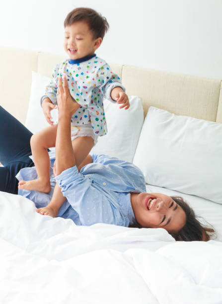 istock Mother And Son Relaxing On Bed 654905896