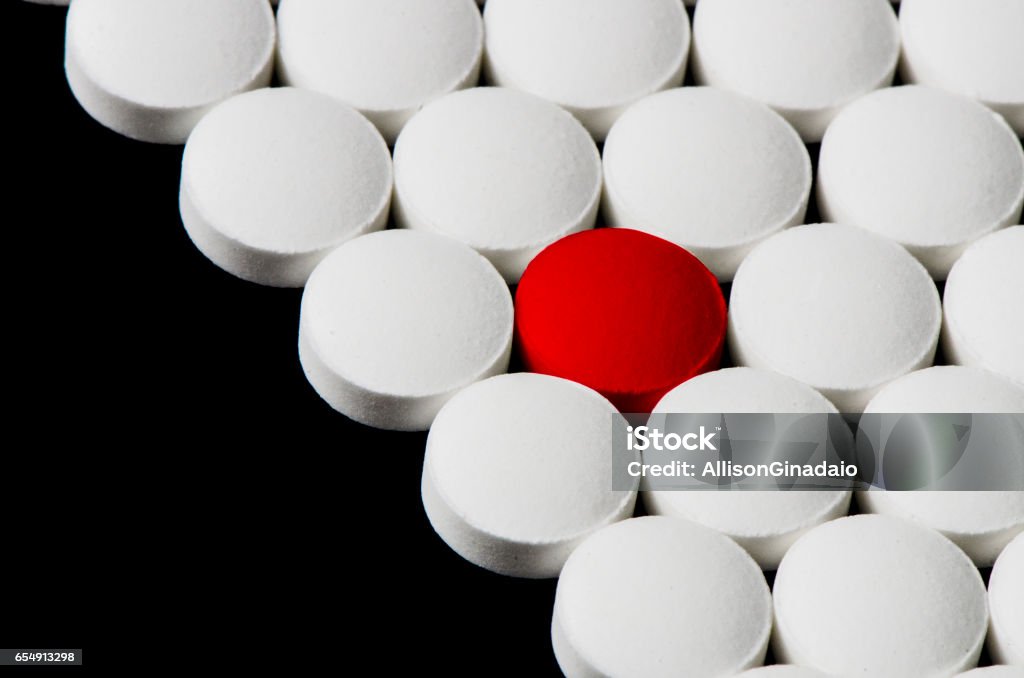 Closeup en pastillas blancas con color rojo - Foto de stock de Adicción libre de derechos