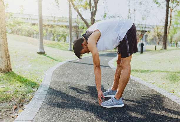 istock Young man stretching bodies, warming up for jogging 654915752