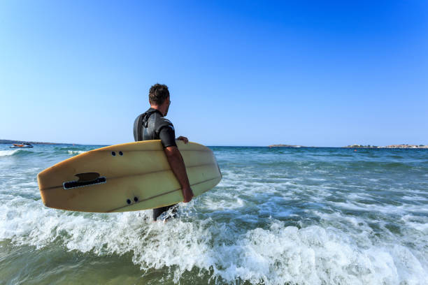 istock Man with surfboard in the sea 654916052