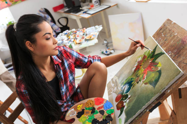 istock Young woman sitting and drawing nature morte 654916504