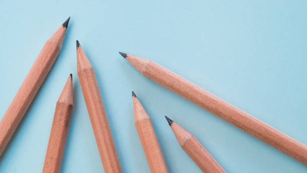 istock Group of sharpened pencils on blue paper from top view point 654920534