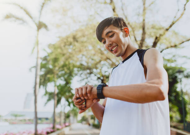 istock Athlete man is looking at smart watch 654926356
