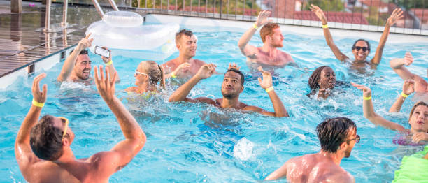 istock Party people in the pool 654939300