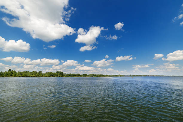 istock Clean lake and beautiful blue sky with clouds 654939398