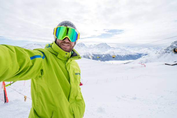 istock Young man taking selfie in ski slope, Switzerland 654939590