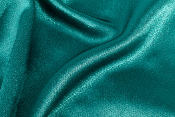 istock Silk background, texture of green  shiny fabric 654945566