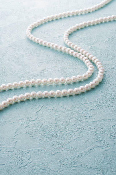 istock pearl necklace and blue back 654953256