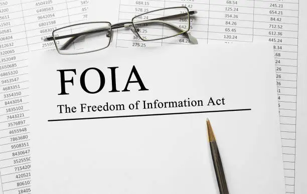 Photo of Paper with The Freedom of Information Act FOIA on a table