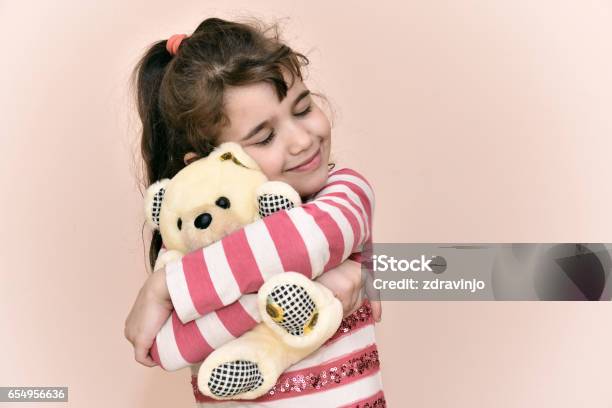 Young Girl And Teddy Bear Stock Photo - Download Image Now - Child, Embracing, Doll