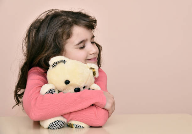 istock Young girl and teddy bear 654956690
