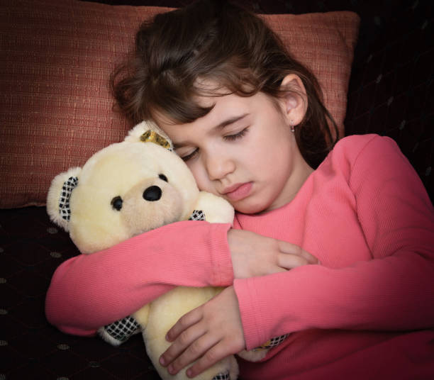 istock Young girl and teddy bear 654956696