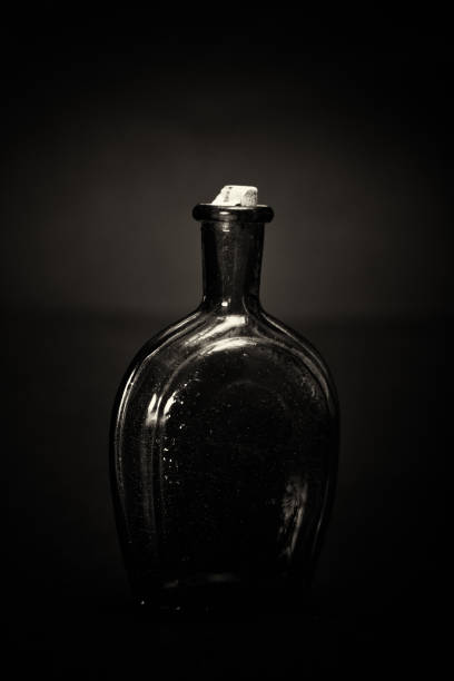 istock Old colourful bottles against a dark background 654956994