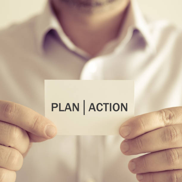 istock Businessman holding PLAN ACTION message card 654957046