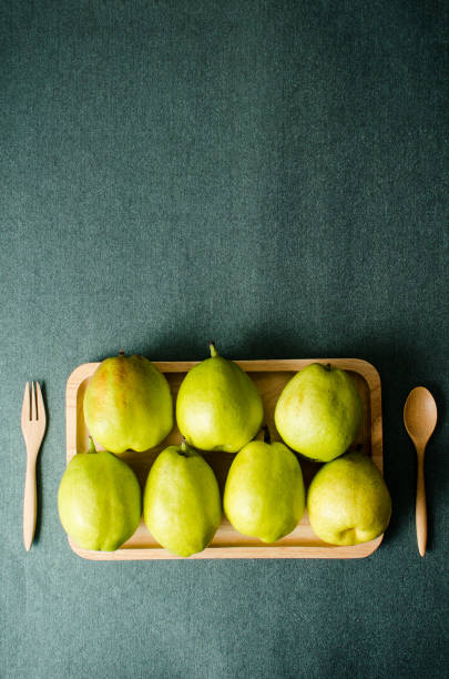 Pears fruit on wooden plate