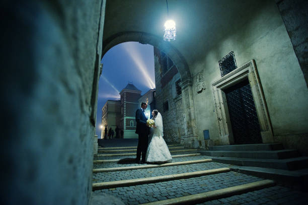 istock Happy wedding couple in evening Krakow 654960274