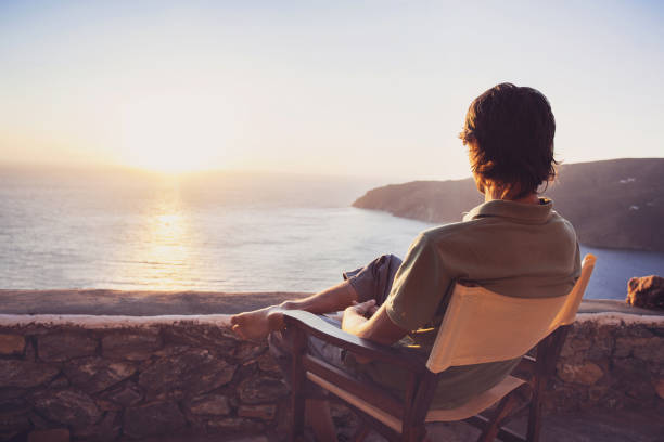 istock Man on vacations relaxing and looking on sunset 654960592