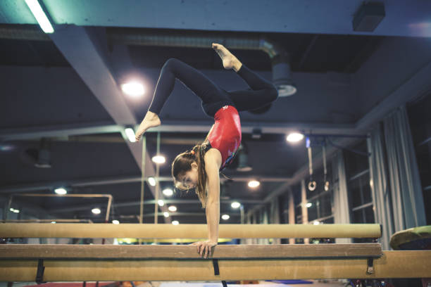 Girl practicing gymnastics stock photo