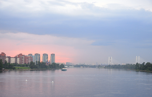 View of Neva river and microdistrict Ribatskoe on the outskirts of St. Petersburg at sunset, Russia.