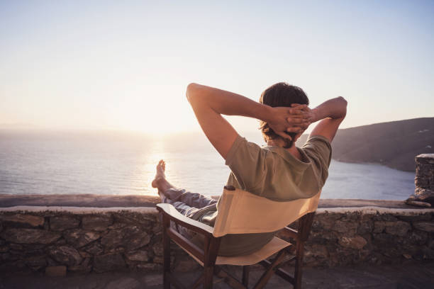 istock Man on vacations relaxing and looking on sunset 654970684