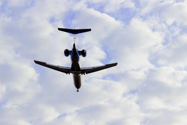 istock Plane flying through clouds in the sky. Jet aircraft. 654971028