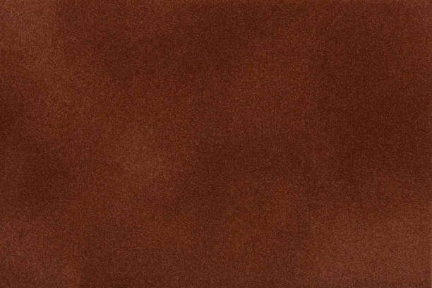 istock Dark brown suede fabric closeup. Velvet texture. 654972288