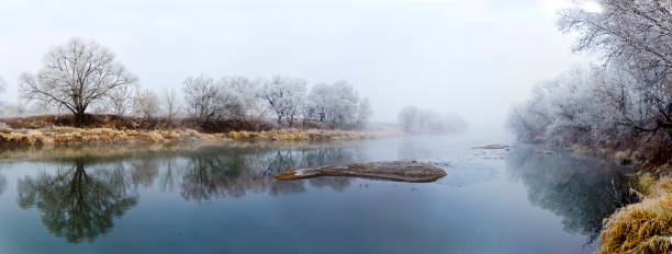 Panoranic view of river at fall misty morning stock photo