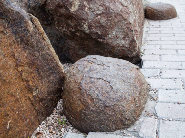 istock Big stones near the paved footpath. 654978296