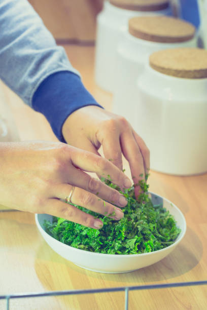 istock Chopped fresh parsley on wooden chopping board 654992792