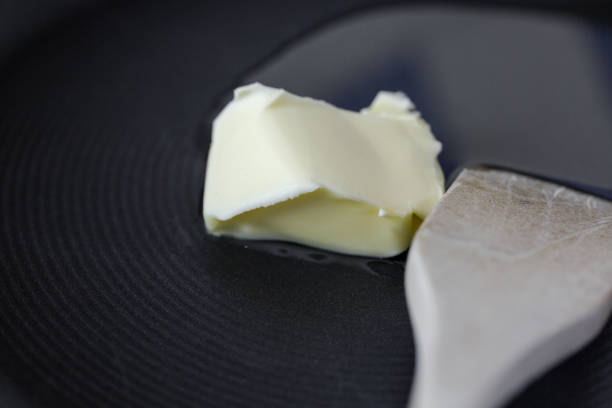 istock Melting butter on hot hard anodized fry pan 654993794