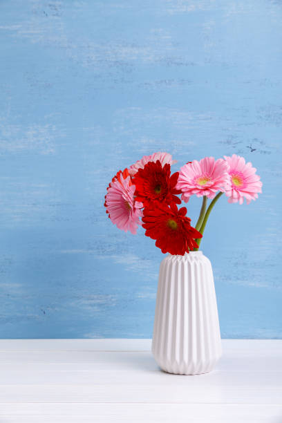 istock Gerbera flowers in vase on wooden background. 655003238