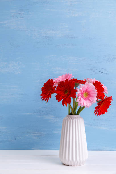 istock Gerbera flowers in vase on wooden background. 655003368