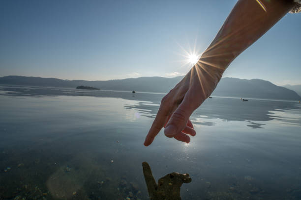 istock Human hand cupped to catch fresh water from lake 655003632