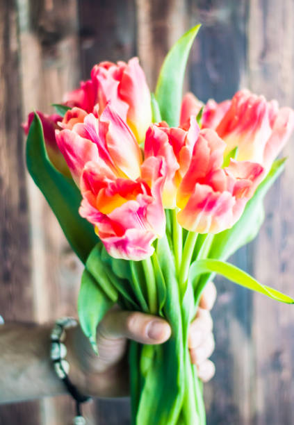istock Still life with tulips on the wooden pattern 655004514