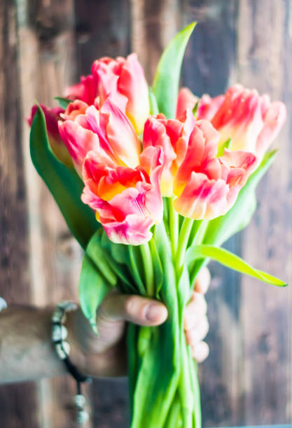 istock Still life with tulips on the wooden pattern 655004528
