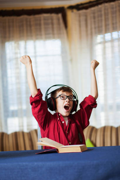 istock Cute boy listening and singing a song with emotions 655005310