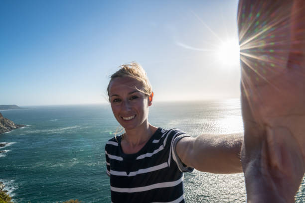 istock Young woman taking selfie with sea view 655009070