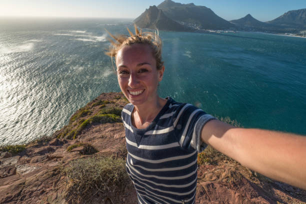 istock Young woman taking selfie with sea view 655012372