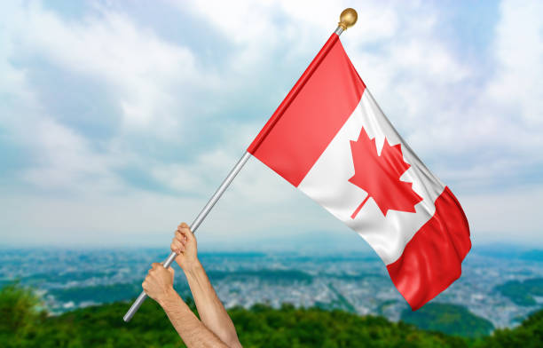 istock Young man's hands proudly waving the Canada national flag 655012410