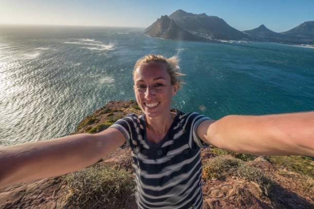 istock Young woman taking selfie with sea view 655014806