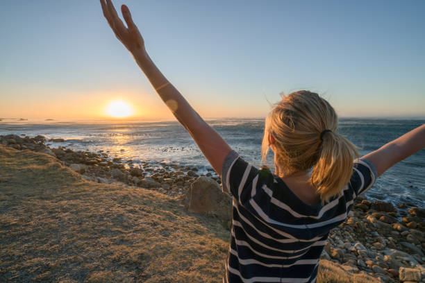 istock Young woman enjoying nature, arms outstretched 655015866
