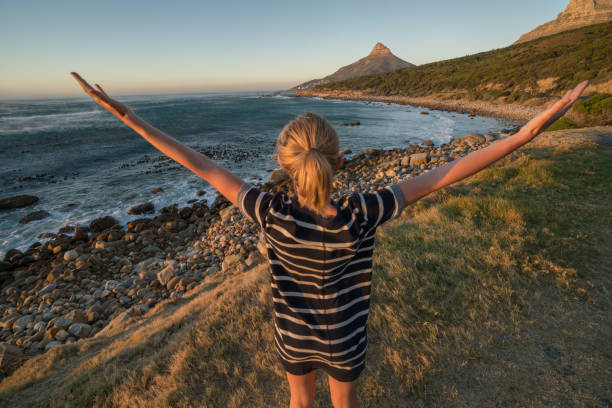istock Young woman enjoying nature, arms outstretched 655015982