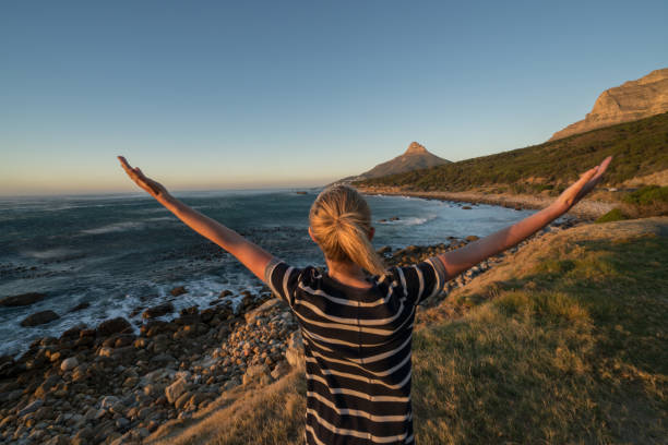 istock Young woman enjoying nature, arms outstretched 655016298