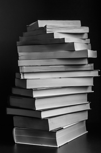swirl of stack of books in black and white closeup