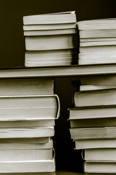 istock stacked books in black and white sepia toned 655016336