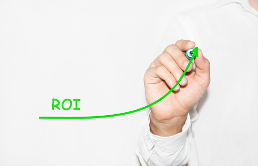Businessman draw growing graph symbolize growing ROI Return On Investment