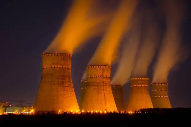 The cooling towers at night of the nuclear power generation plant