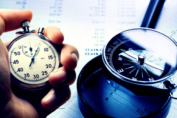 istock Hand holding stopwatch on budget numbers 655023268